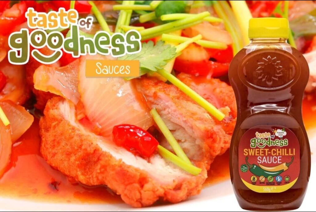 Bottle of taste of goodness sweet chilli sauce with sweet chilli chicken strips as the background